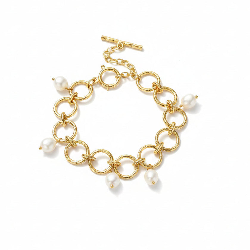 Open bracelet showing the pearl charms, link structure and toggle closure.