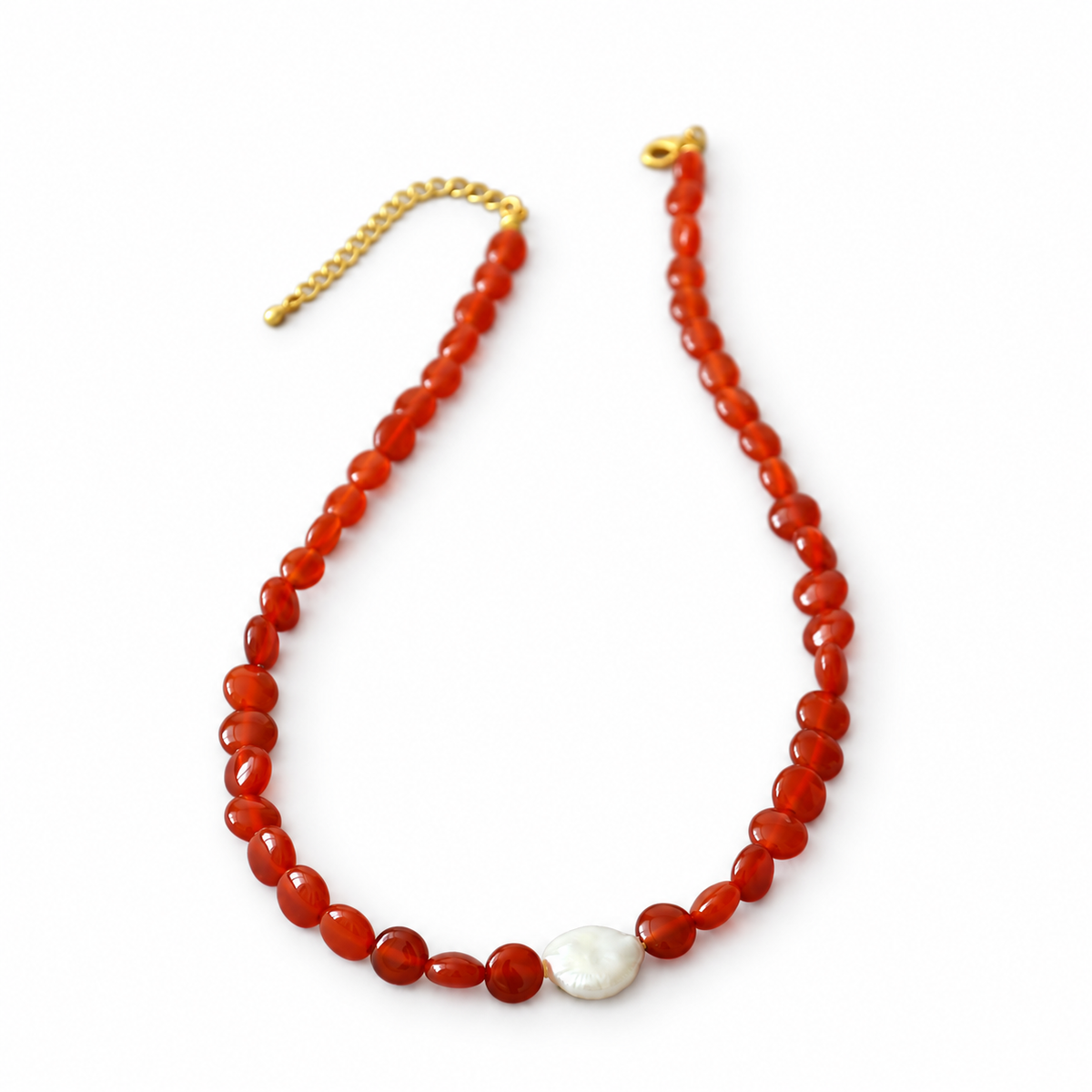 Red beaded necklace with a single irregular white pearl accent and gold-tone clasp.