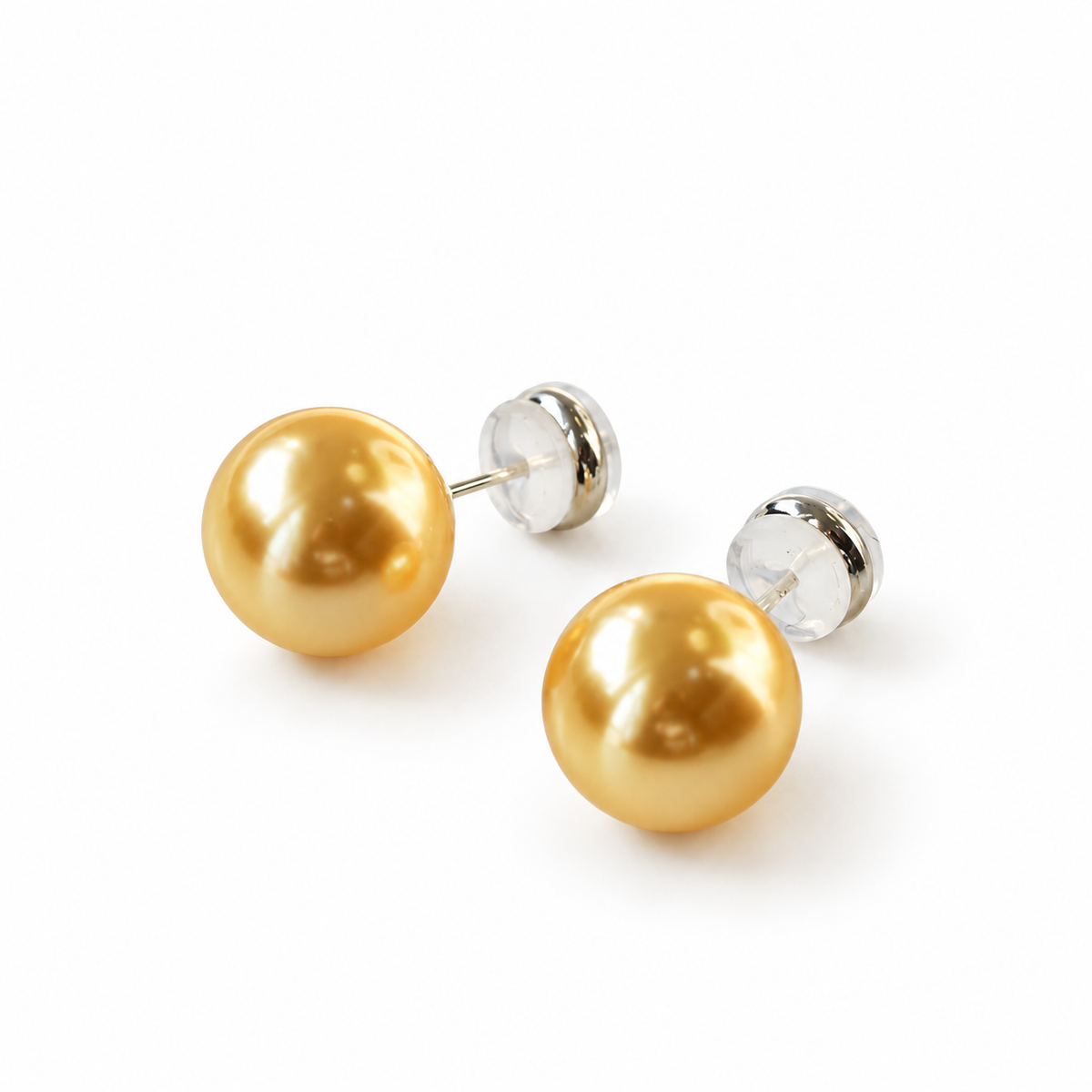 Pair of gold-colored round stud earrings with straight posts and clear round backs.