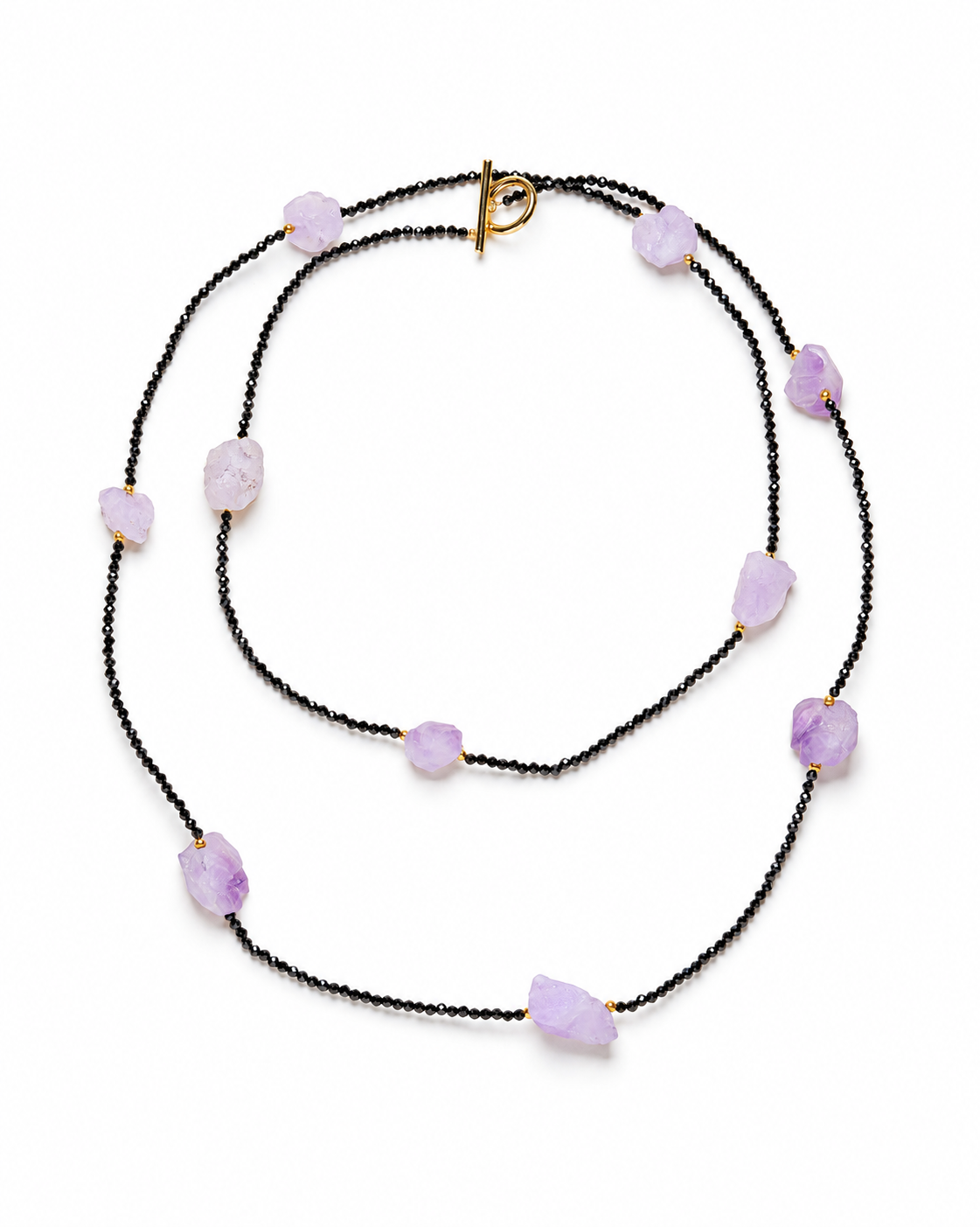 Long black-beaded necklace with ten irregular pale-purple stones and a gold-tone toggle clasp.
