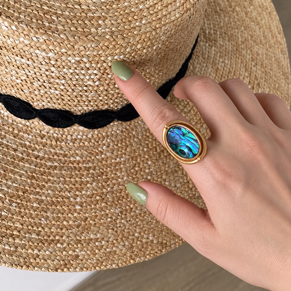 Iridescent Abalone Shell Ring worn on a hand.