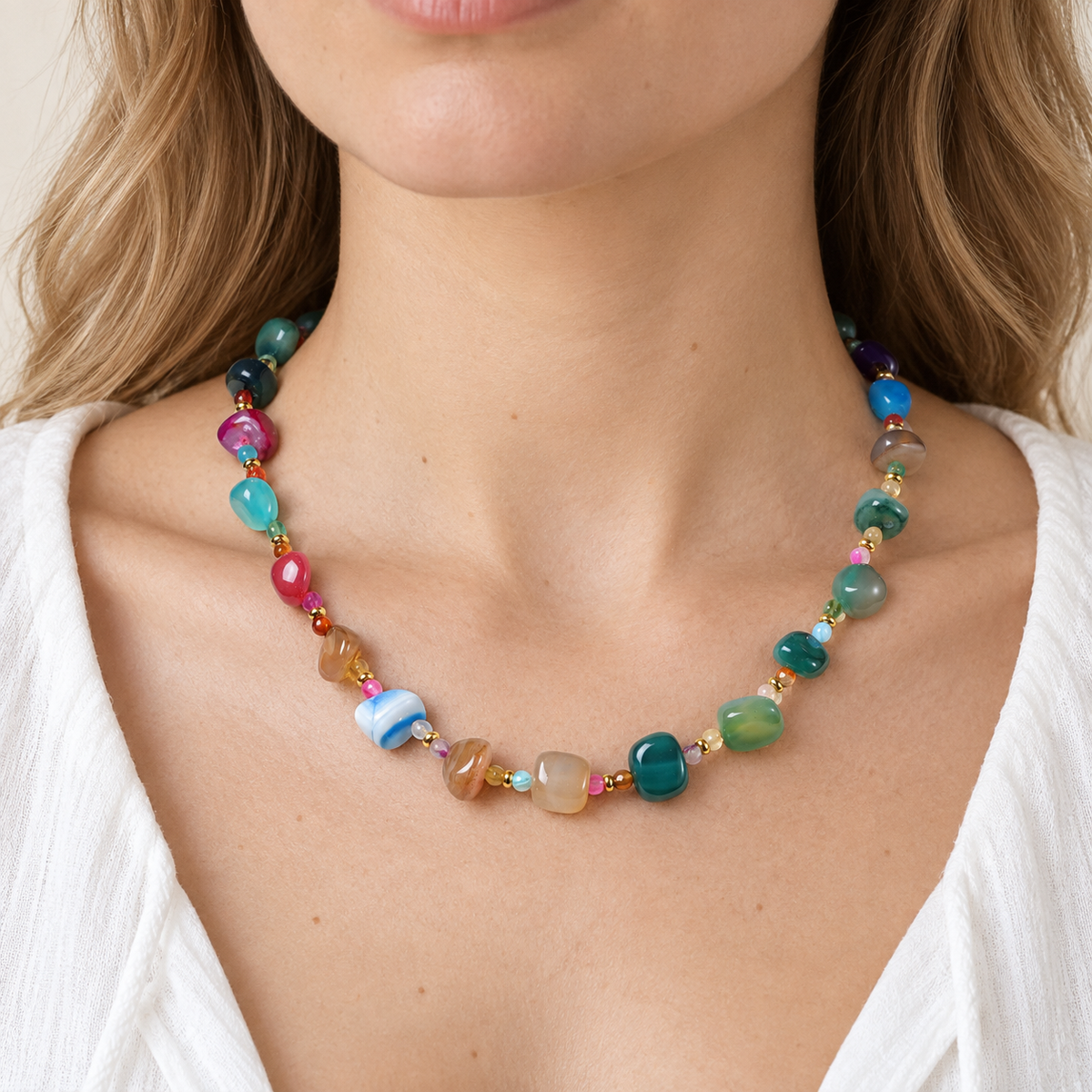 Rainbow Agate Chip Necklace worn with a white shirt, showing its multicoloured irregular stones and small spacers.