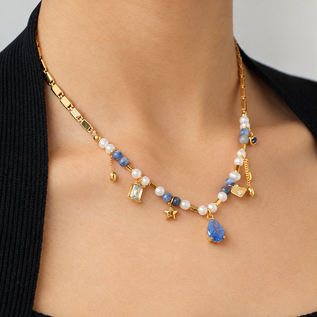 Blue Pearl Zircon Necklace worn in a close-up detail view