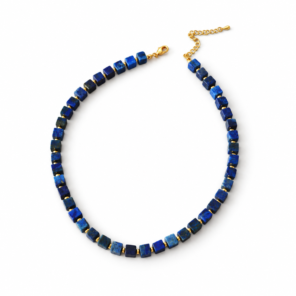 Blue cube-bead necklace with small gold-colour spacers, clasp and extension chain on white.