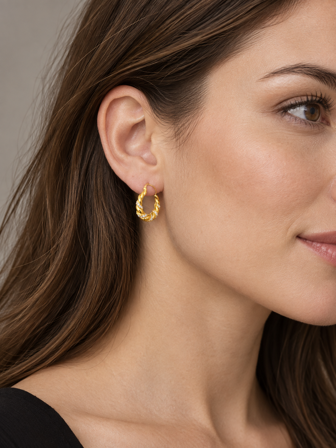 Twist Zirconia Hoop Earrings worn on an adult model.