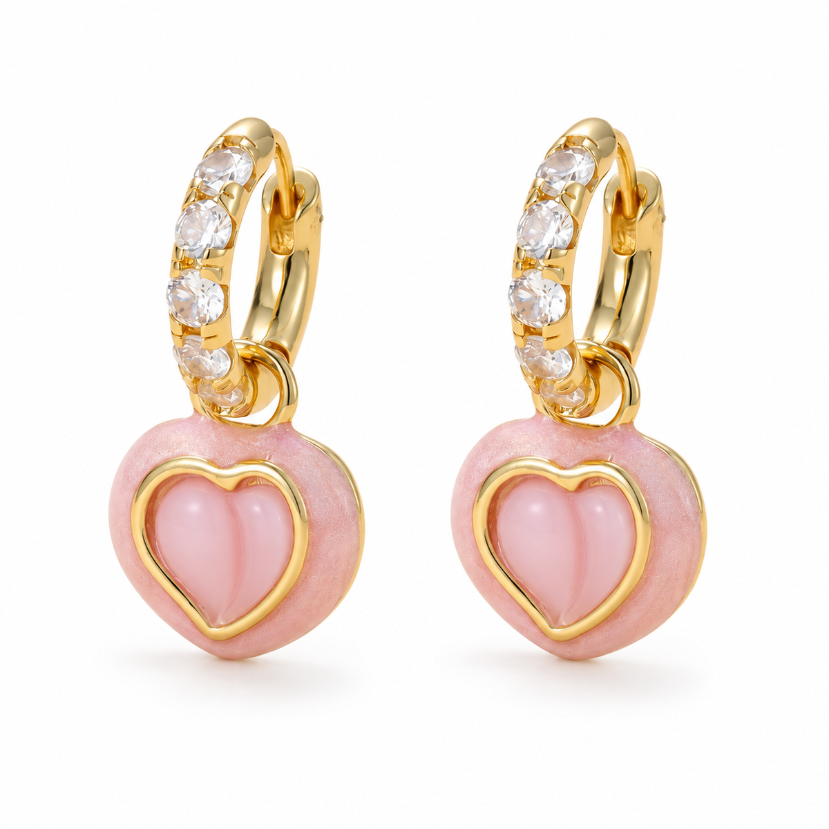 Pair of gold-plated hoop earrings with pink heart charms on a white background.