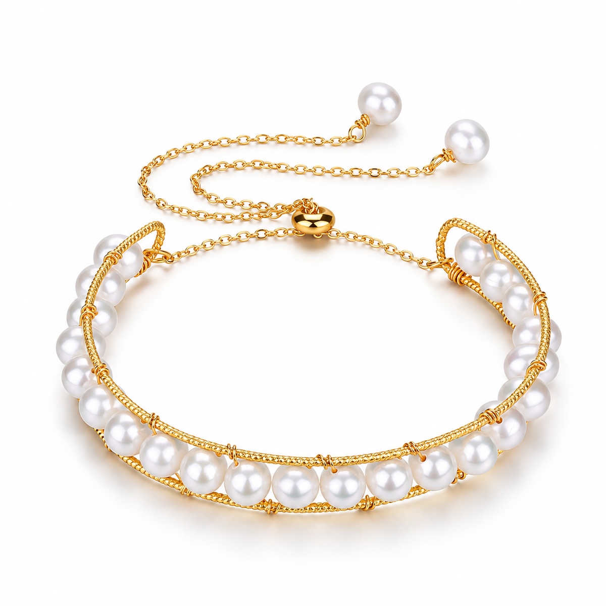 A gold-tone adjustable pearl bracelet with textured rails, a sliding clasp and two pearl-tipped chain ends on white.