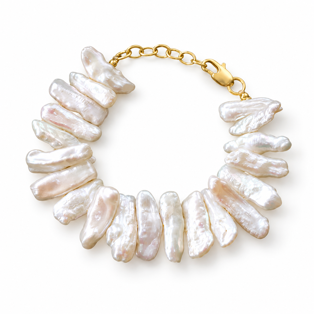 An elongated baroque pearl bracelet arranged in a circle with a gold-tone clasp and extension chain on white.