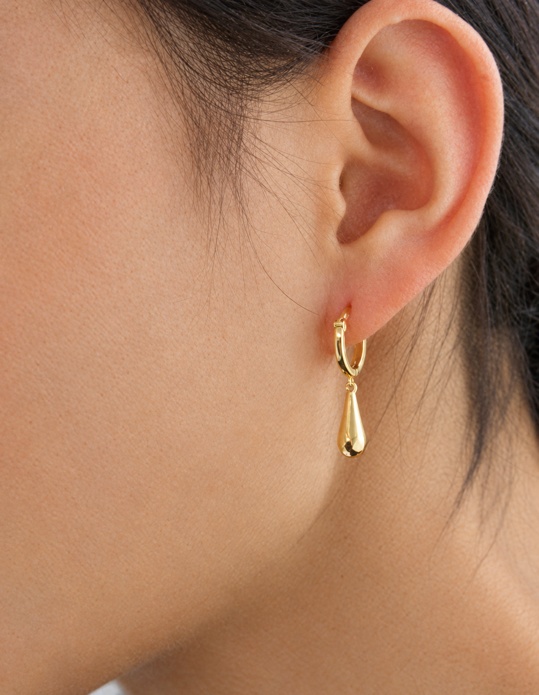 Briolette Drop Huggie Hoop Earrings worn on the ear, close-up detail