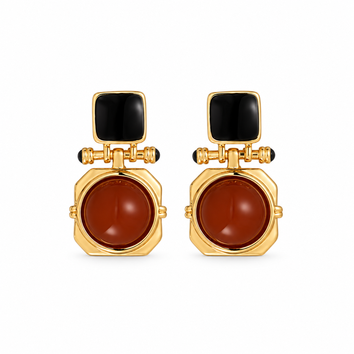 A pair of gold-tone geometric earrings with black square studs and reddish-brown round drops on white.